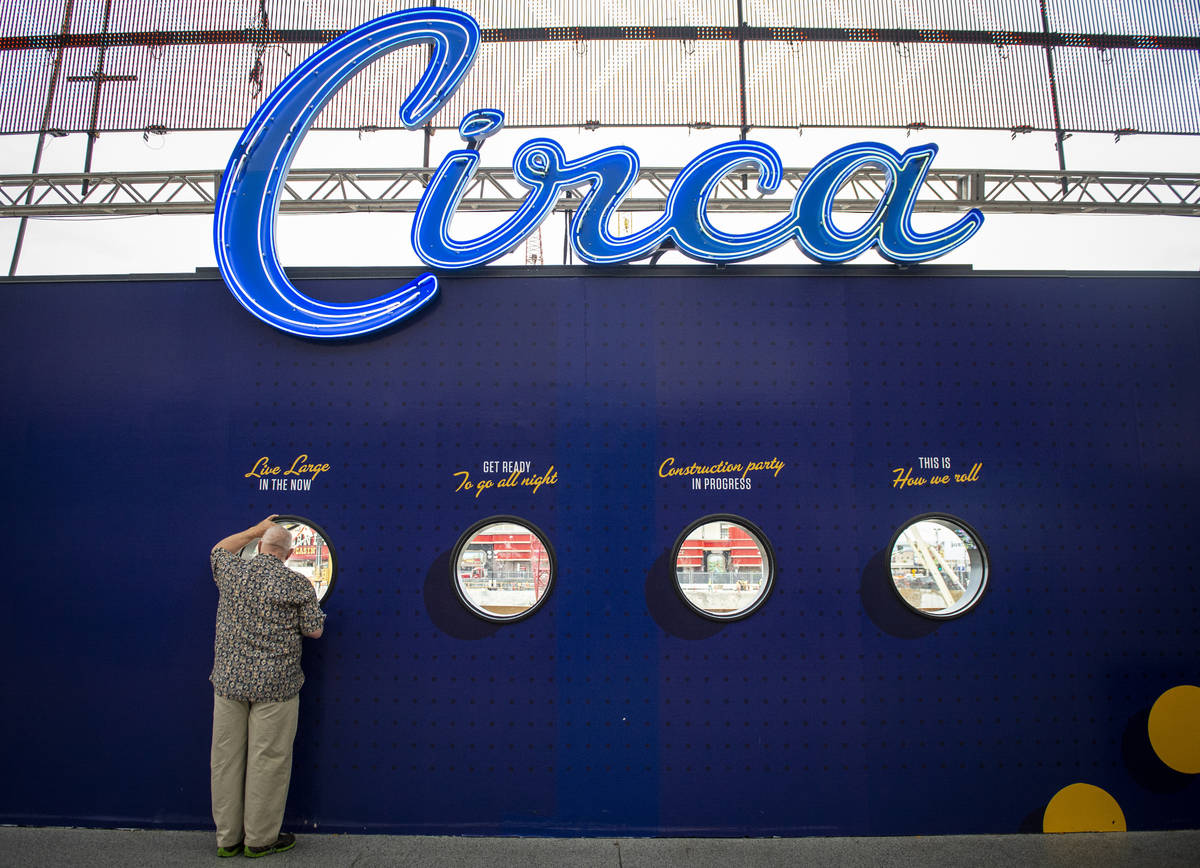 A man looks through one of the windows looking out on the construction for Circa Resort and Cas ...