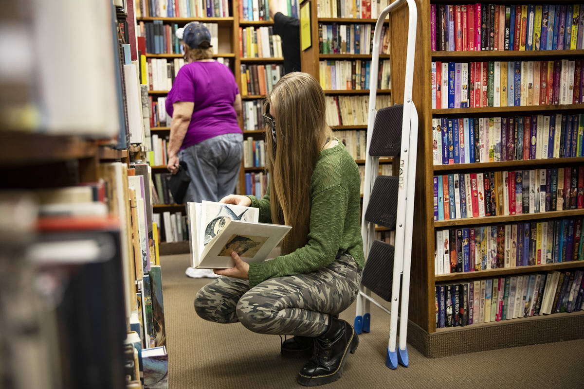 Lily Gensler, 17, shops for books at Amber Unicorn Books in Las Vegas, Wednesday, Oct. 21, 2020 ...