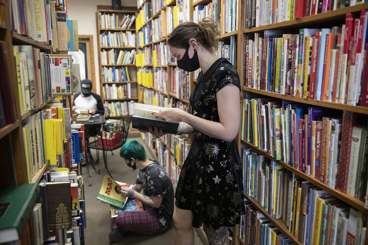 Friends Mercury Taft, left, and Stephanie Lehr, right, shop for books at Amber Unicorn Books in ...