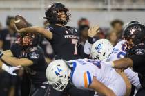 UNLV Rebels quarterback Kenyon Oblad (7) just gets a pass off before the rush from Boise State ...