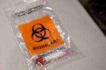 A completed COVID-19 test is seen in a biohazard bag during a preview of COVID-19 testing site ...