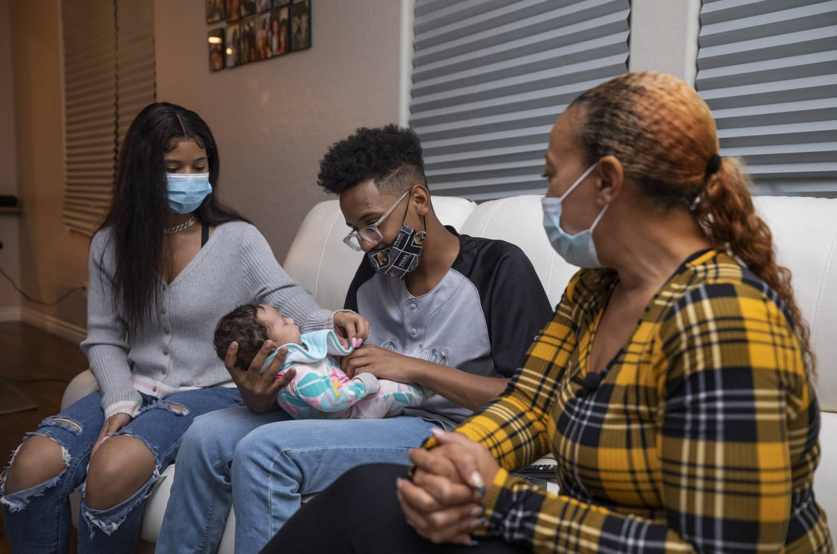 From left, Ebonee Levi, 17, Tavaras Chandler Jr., 14, holding 2-month old Zoie Chandler, and Da ...