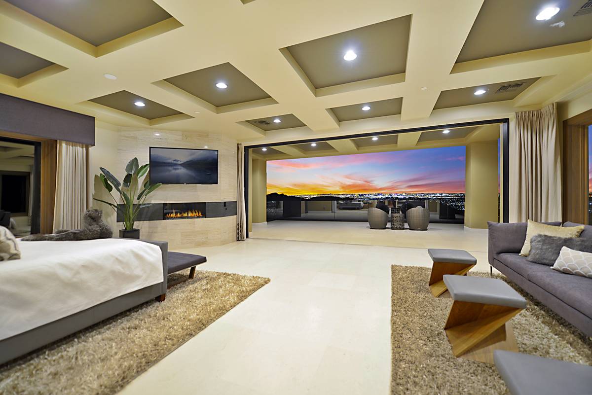 The upstairs master suite features a disappearing wall that allows for sweeping views of the La ...