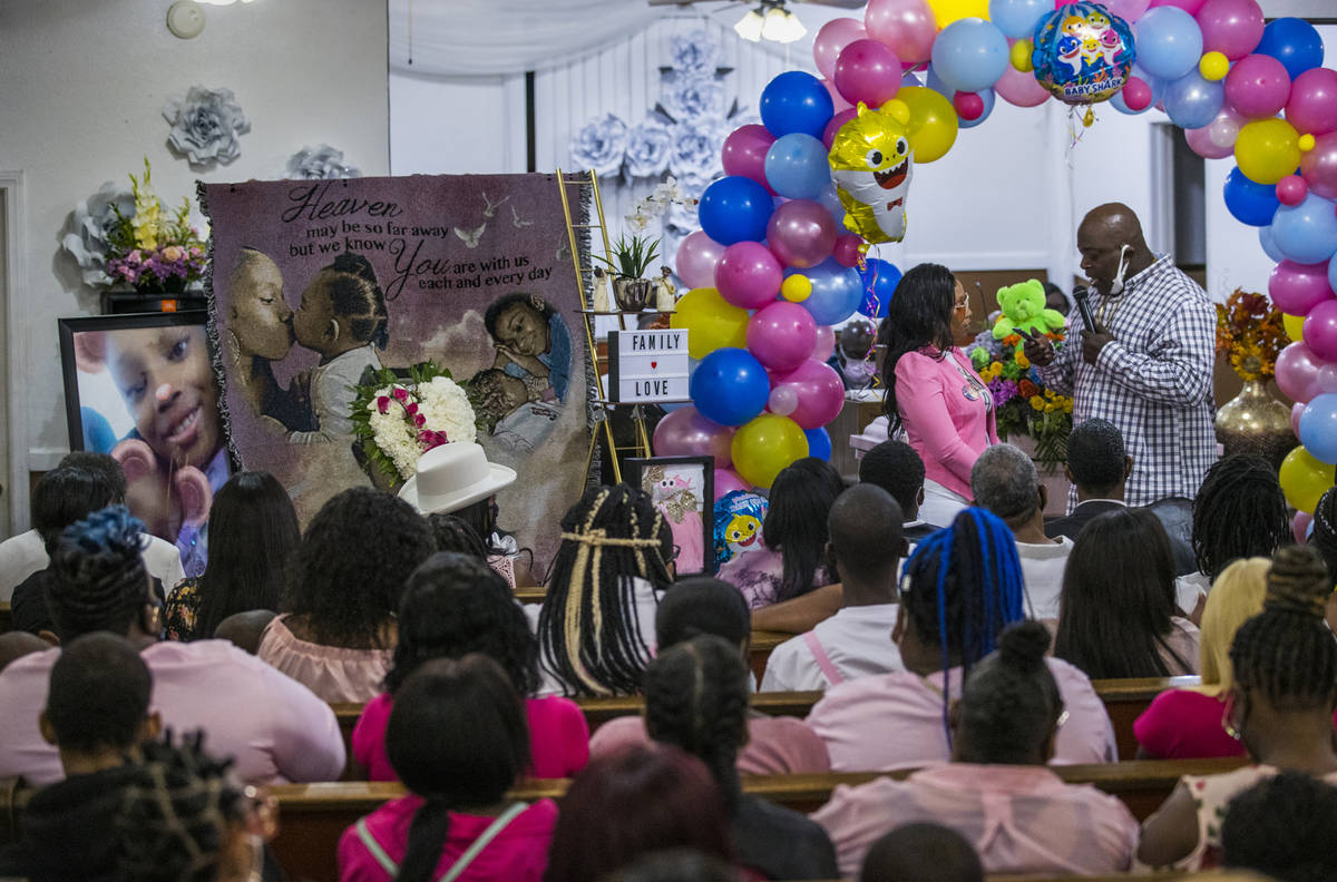 Mario Hunt, right, recites a poem he wrote for Sayah Deal to her mother Mariah Coleman during t ...