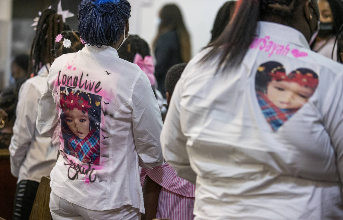 Mourners display caring messages on their clothing during the funeral service for Sayah Deal at ...