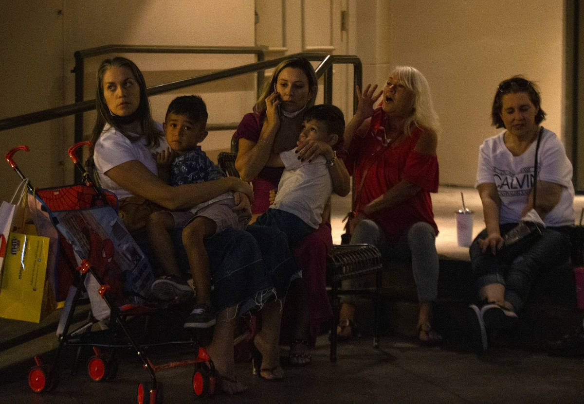 Damaris Luquez and her 5-year-old son Rabhael Lima, left, wait outside Paris Las Vegas after a ...