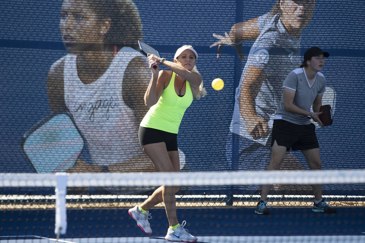 Christee Chargot of Astro, Fla., returns the ball to Jean Halaham of Washingtonville, N.Y., dur ...