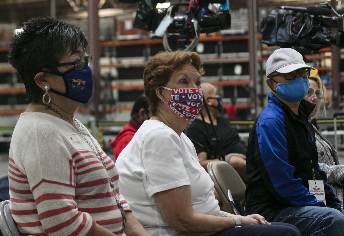 Election observers, Michelle Barnes, left, Donna West, and Raul Sabido, right, watch as Clark C ...