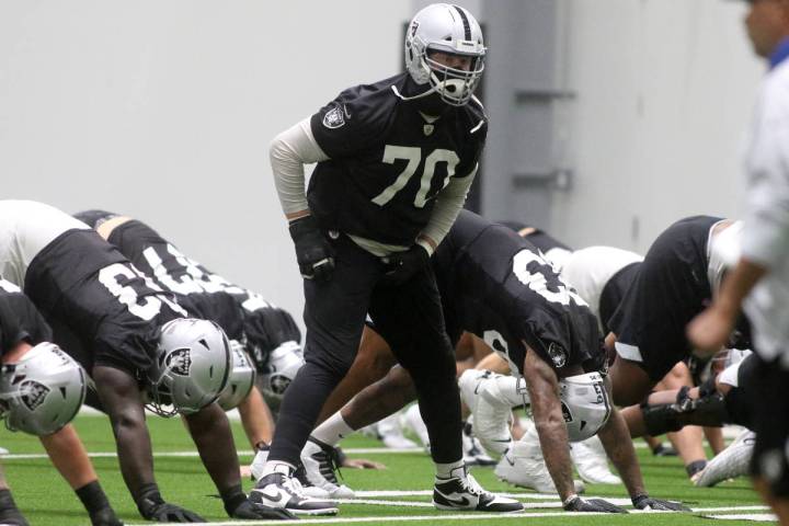Las Vegas Raiders offensive tackle Sam Young (70) stretches during a practice session at the te ...