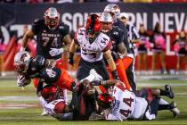 UNLV Rebels running back Charles Williams (8) dives over San Diego State Aztecs safety Trenton ...