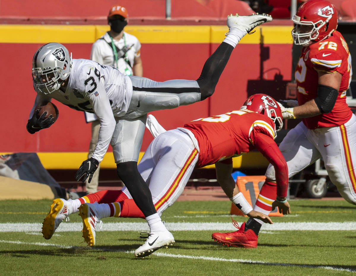 Las Vegas Raiders strong safety Jeff Heath (38) leaps over Kansas City Chiefs quarterback Patri ...