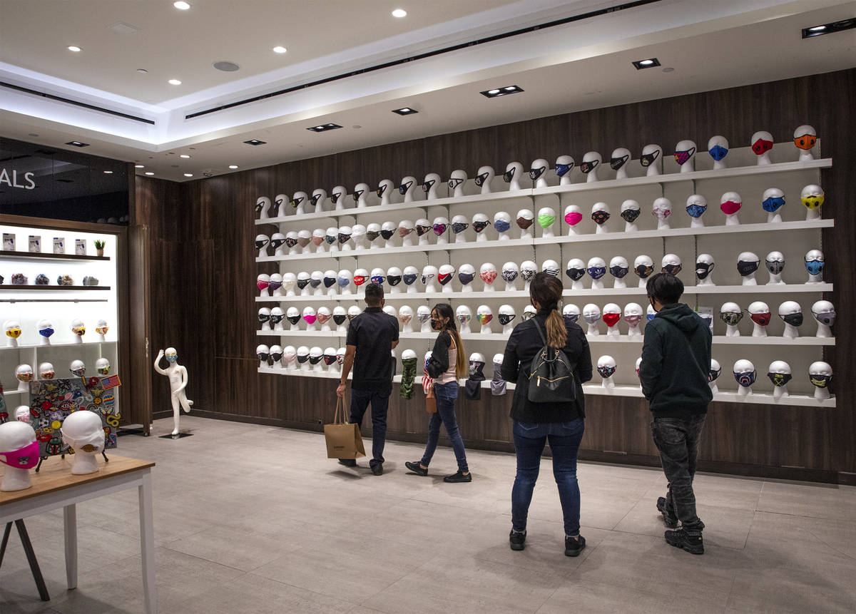 Customers shop at the COVID-19 Essentials store in the Forum Shops at Caesars Palace in Las Veg ...