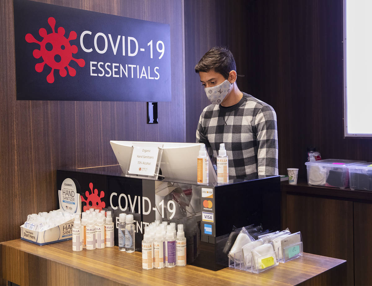 Salesperson Lucas Nascimento works at the computer at the COVID-19 Essentials store in the Foru ...