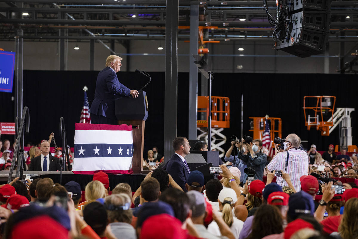 President Donald Trump addresses a large crowd at a campaign rally at Xtreme Manufacturing in H ...