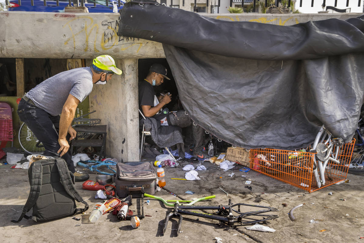 Crossroads CEO Dave Marlon, left, offers food, drink and medical resources to the homeless whil ...