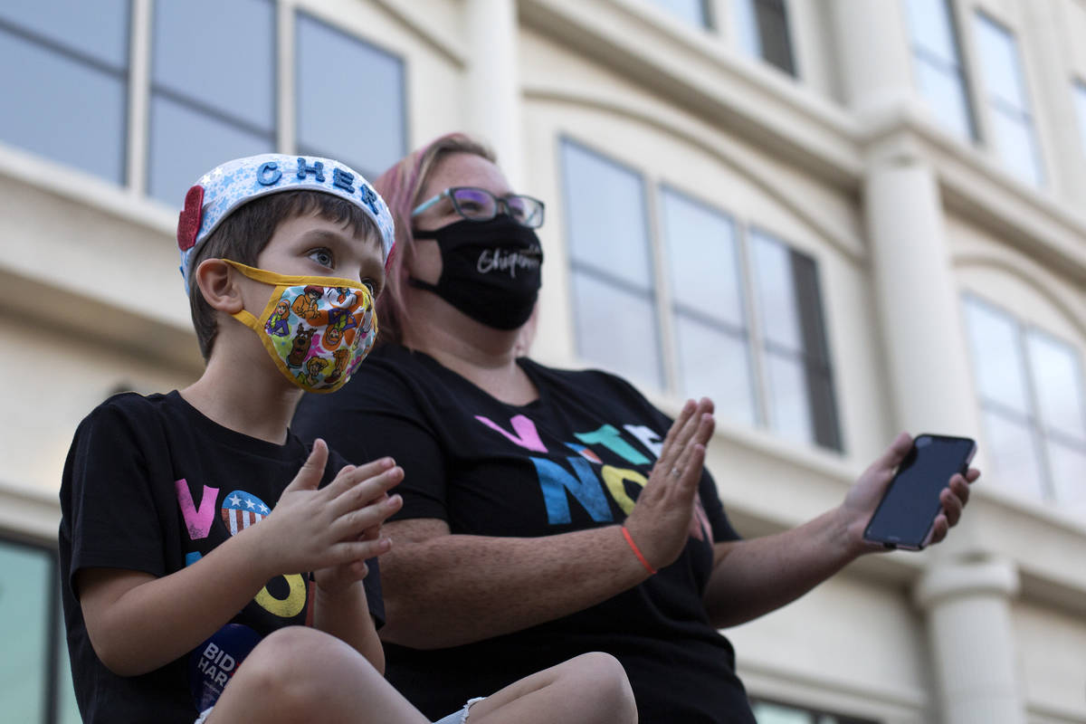 Frederick Scriver, 5, and his mom Courtney Hart dance along to Cher's performance at a voter mo ...