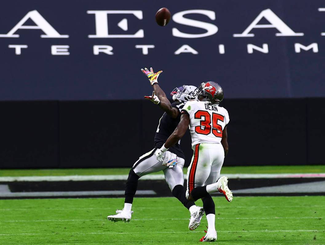 Las Vegas Raiders wide receiver Henry Ruggs III (11) comes up short on a catch under pressure f ...