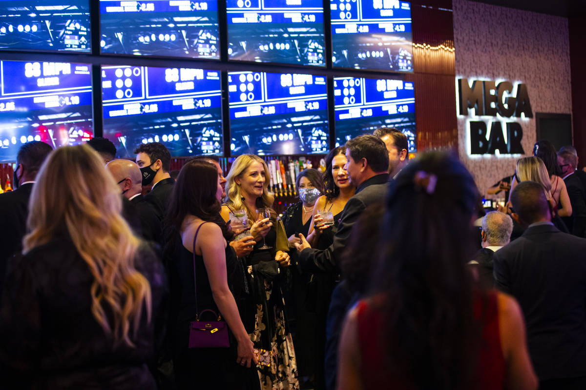 Invited guests enjoy drinks by the Mega Bar at Circa during the VIP black-tie grand opening eve ...