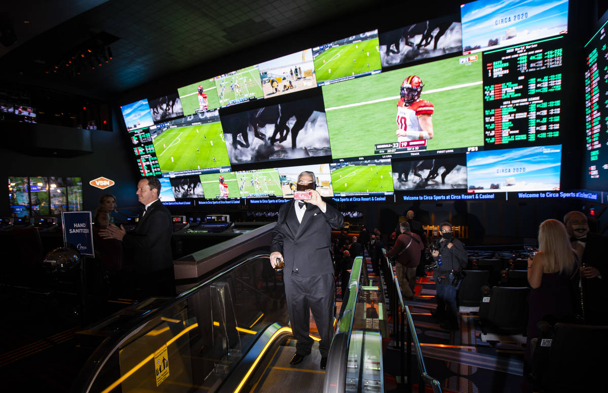 Invited guests explore Circa Sportsbook during the VIP black-tie grand opening event in downtow ...