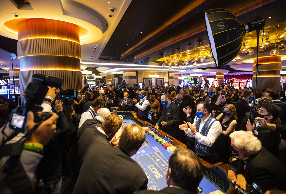 Dealers clap right before the first roll of the dice is thrown at a craps table at Circa during ...