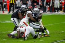 Las Vegas Raiders center Rodney Hudson (61) tries to assist as running back Josh Jacobs (28) is ...