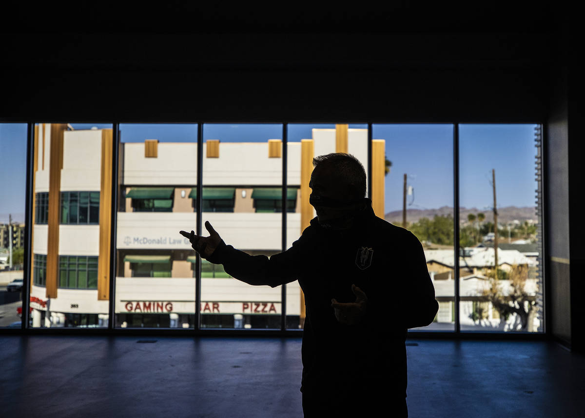 Darren Eliot, vice president of hockey programming and facility operations, points out features ...