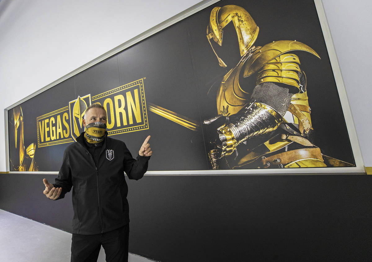 Darren Eliot, vice president of hockey programming and facility operations, points out features ...