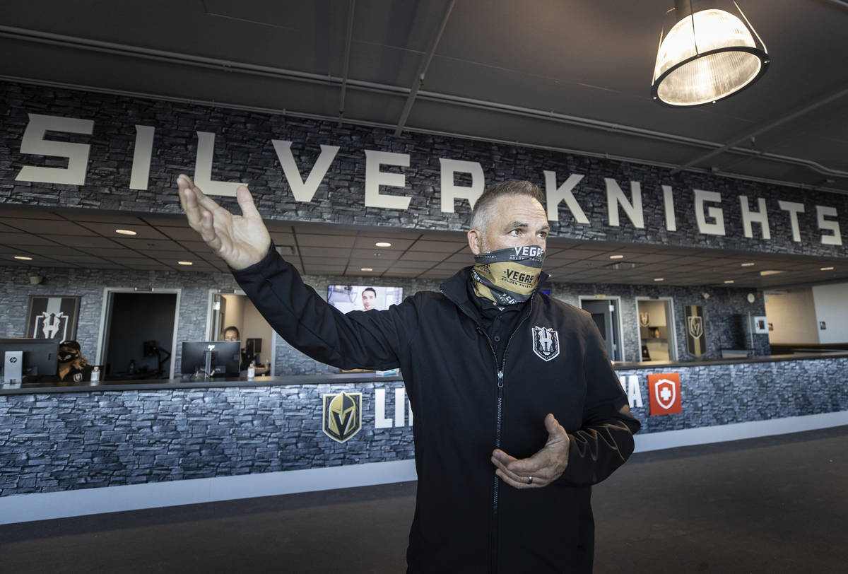 Darren Eliot, vice president of hockey programming and facility operations, points out features ...