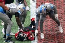 Detroit Lions players point at the football held by Atlanta Falcons' Todd Gurley during the fou ...