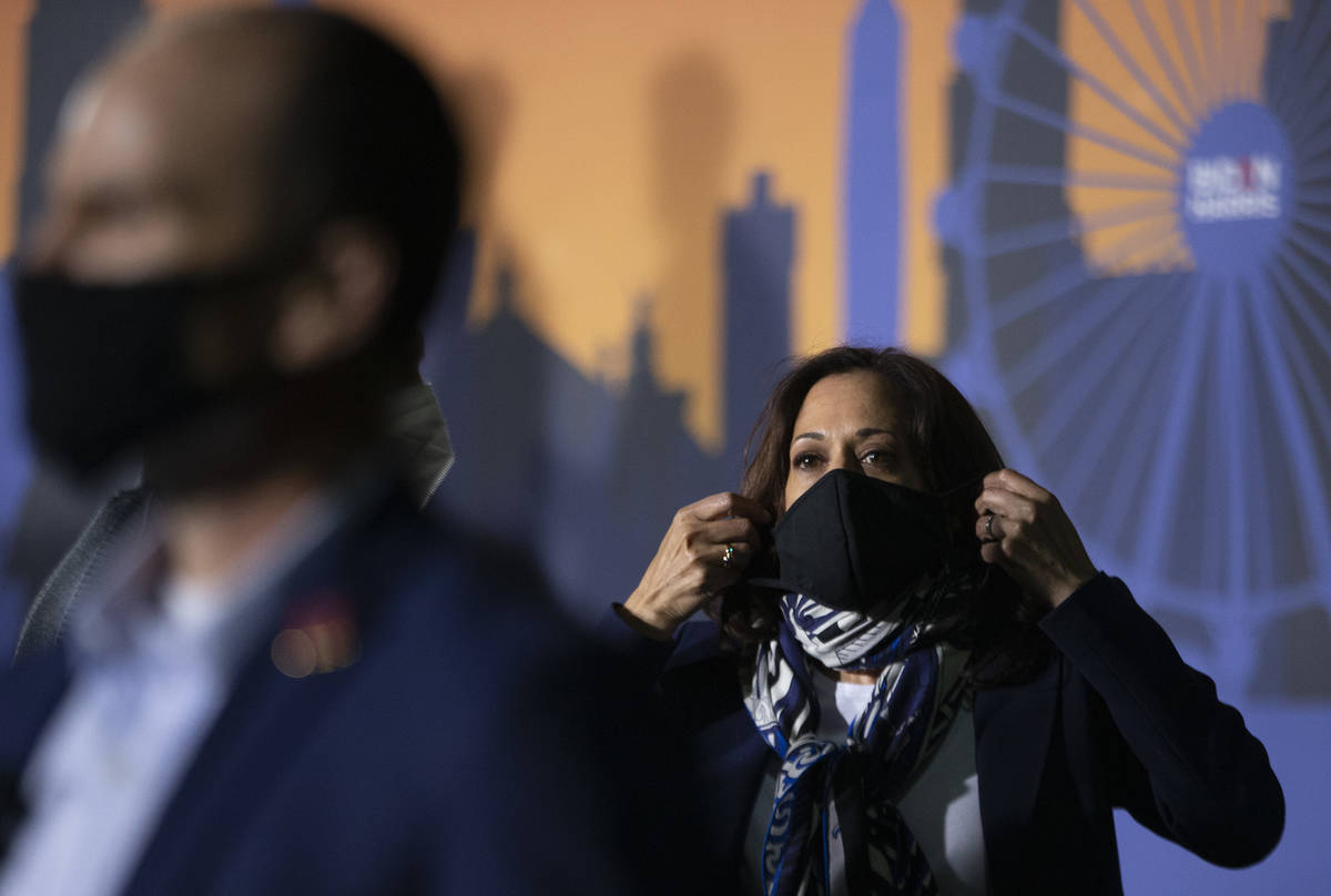 Sen. Kamala Harris puts her mask back on after speaking at Kianga Isoke Palacio Park on Tuesday ...