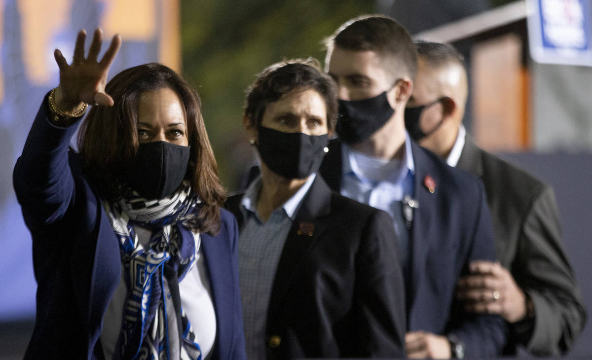 Vice presidential candidate Sen. Kamala Harris waves goodbye to the audience following her camp ...