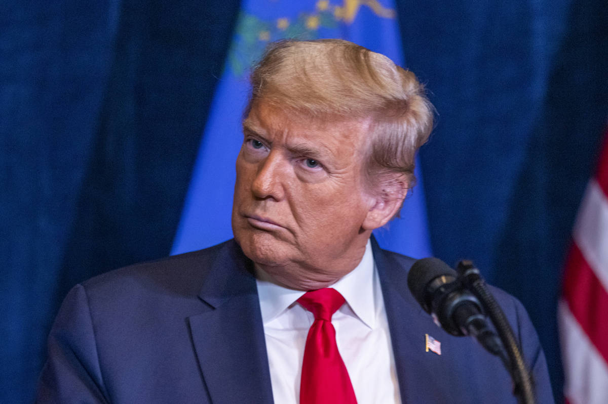 President Donald Trump listens to a reporterÕs question during a press conference with Nev ...