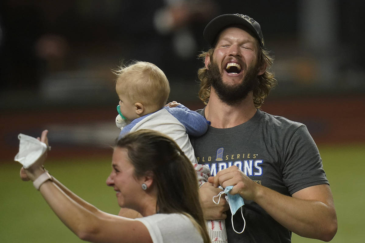 Los Angeles Dodgers pitcher Clayton Kershaw celebrates with family after defeating the Tampa Ba ...