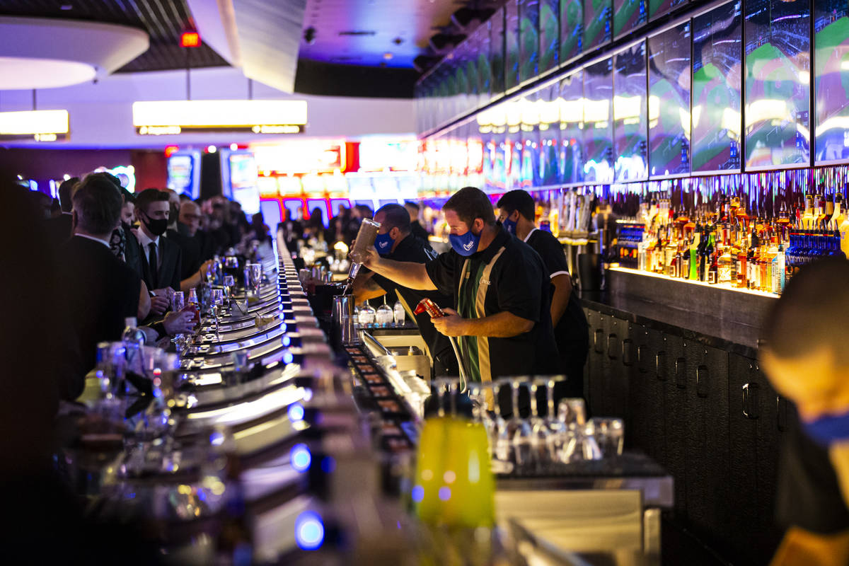 Bartenders prepare drinks at the Mega Bar at Circa during the VIP black-tie grand opening event ...