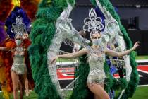 Las Vegas performers, including Elaine Hayhurst, right, put on a show at Allegiant Stadium as p ...