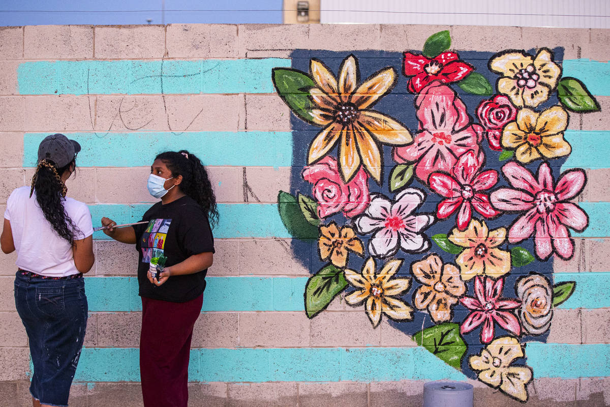 Artists Angie Castillo, left, and Vivian Avila work on a mural at the site of the former Moulin ...