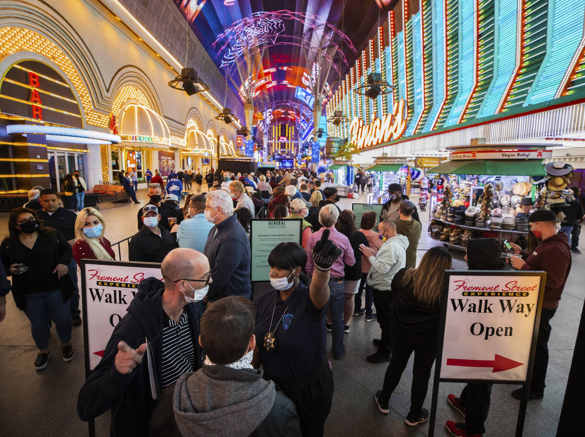 People wait in line for blocks at the Fremont Street Experience to enter Circa during the resor ...