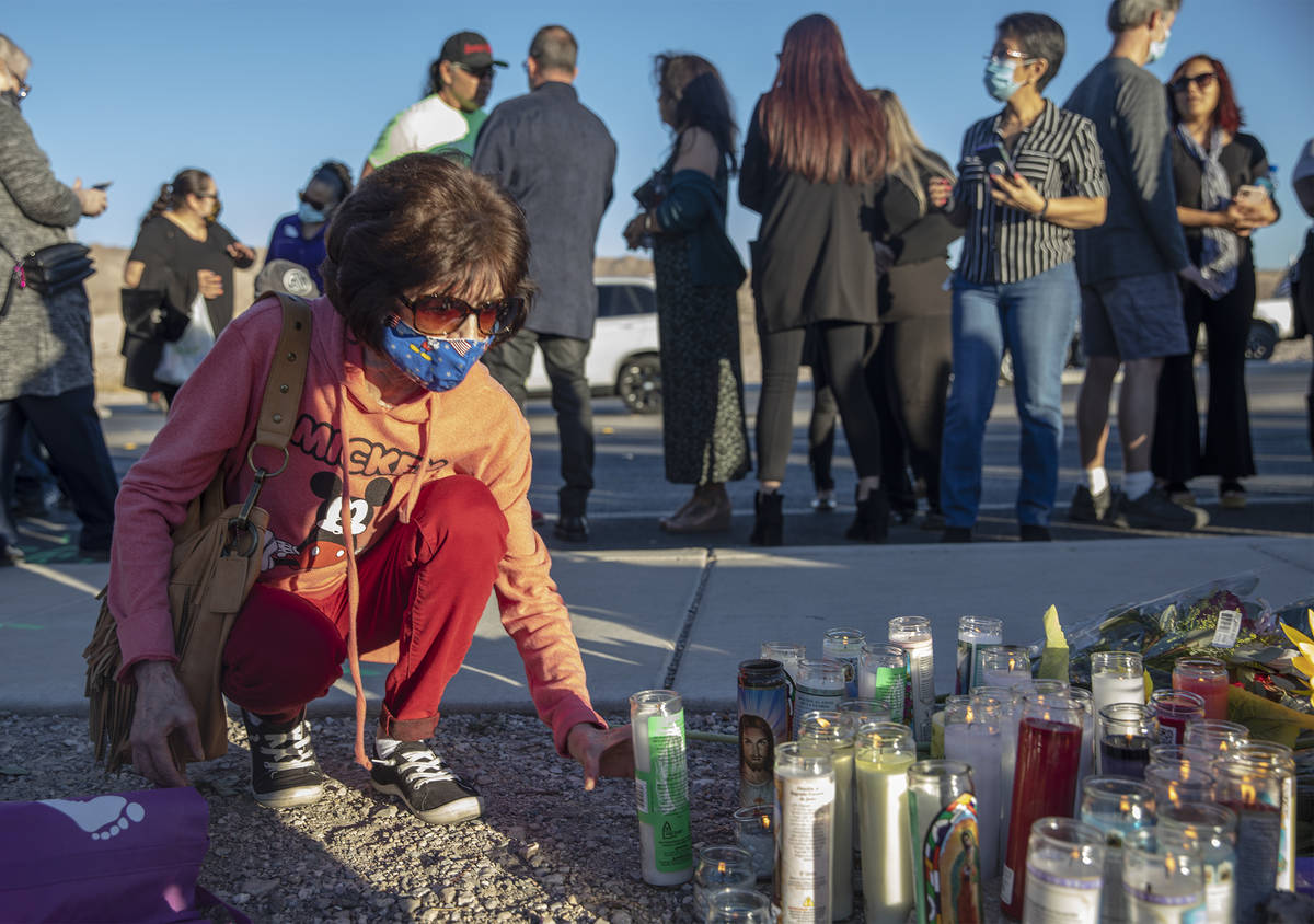 Karen Reda places a candle at a makeshift memorial in honor of her sister Michelle Weissman, a ...