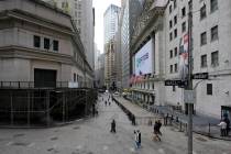 Visitors to the financial district walk past the New York Stock Exchange, Wednesday, Oct. 28, 2 ...