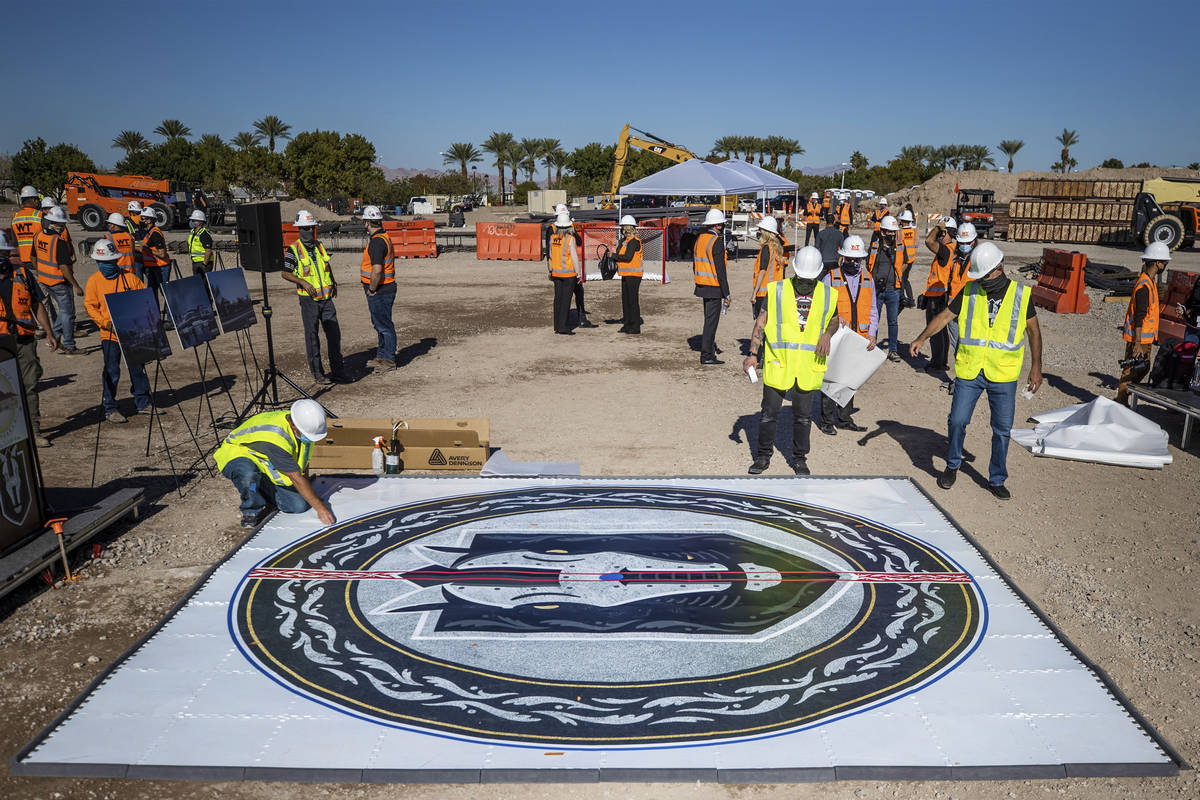 Construction workers put the finishing touches on the Henderson Silver Knights logo during a co ...