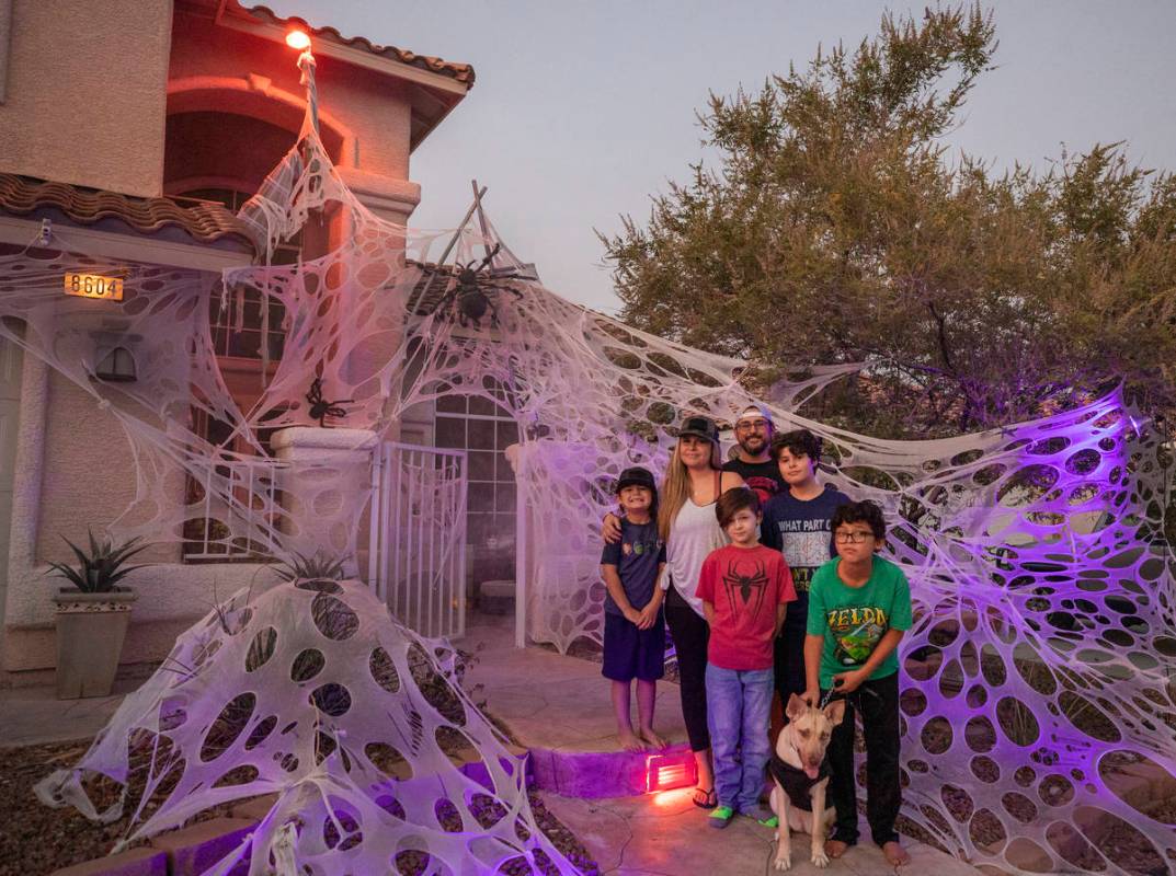 Tiffany and Leroy Garcia are photographed with their four sons in front of their Disney inspire ...