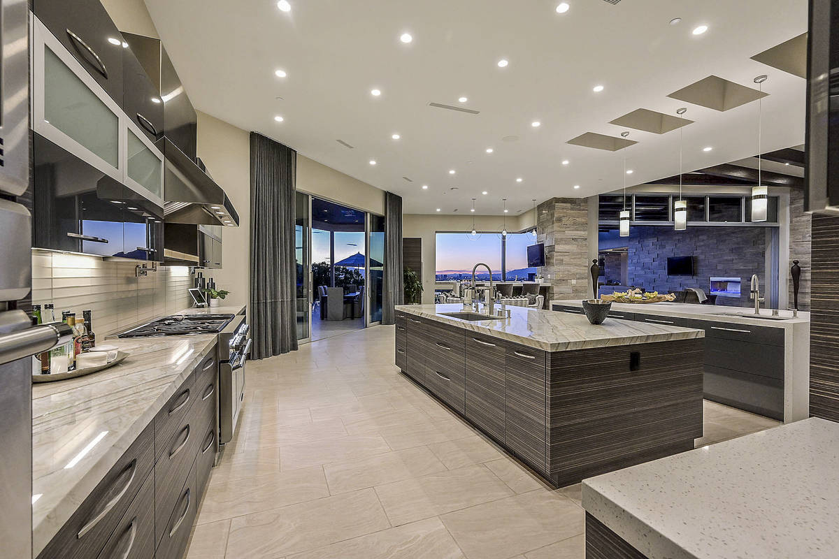 The kitchen opens to the pool area. (Huntington and Ellis)