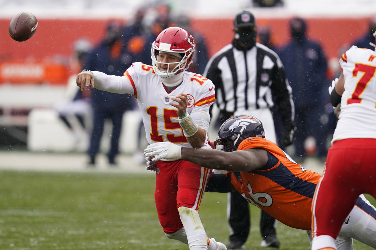 Kansas City Chiefs quarterback Patrick Mahomes throws a pass under pressure  from Denver Broncos …