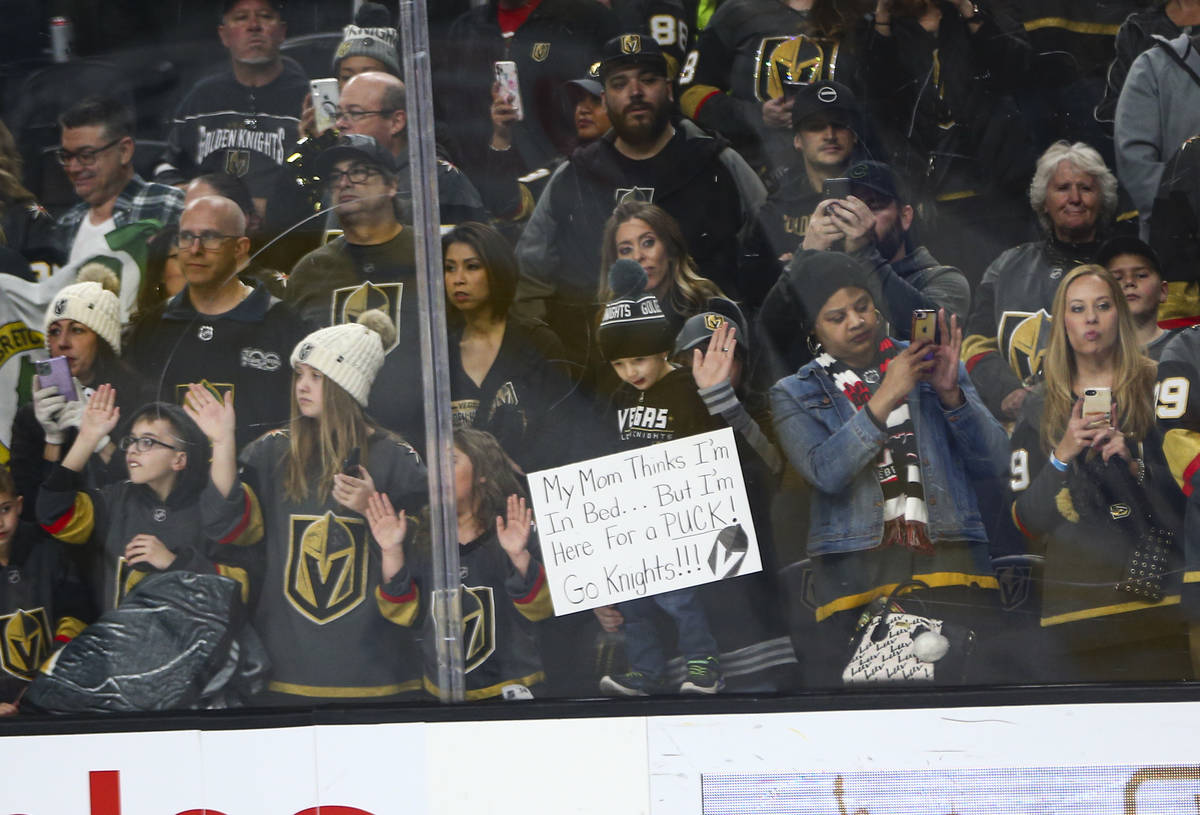 Golden Knights fans watch the team warm up before the start of an NHL hockey game against the C ...