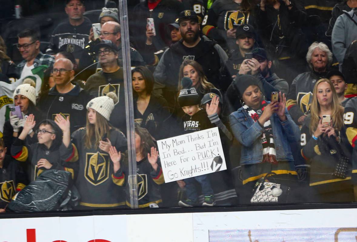 Golden Knights fans watch the team warm up before the start of an NHL hockey game against the C ...