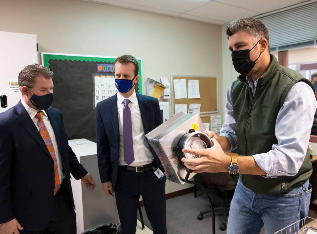Matt Lisiewski, vice president at Norman S. Wright mechanical equipment, right, demonstrates ho ...