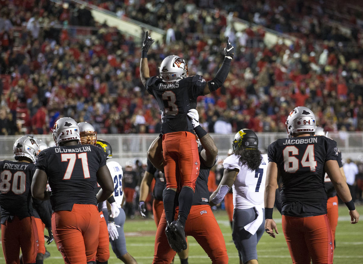 UNLV Rebels running back Lexington Thomas (3) celebrates with teammates after scoring a touchdo ...