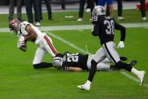 Las Vegas Raiders free safety Erik Harris (25) tackles Tampa Bay Buccaneers wide receiver Mike ...