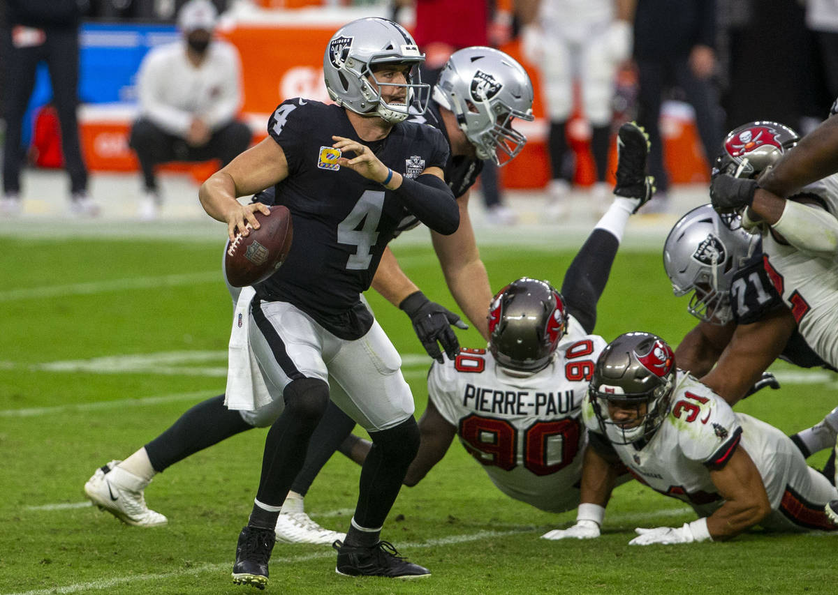 Las Vegas Raiders quarterback Derek Carr (4) looks to pass against the against the Tampa Bay Bu ...