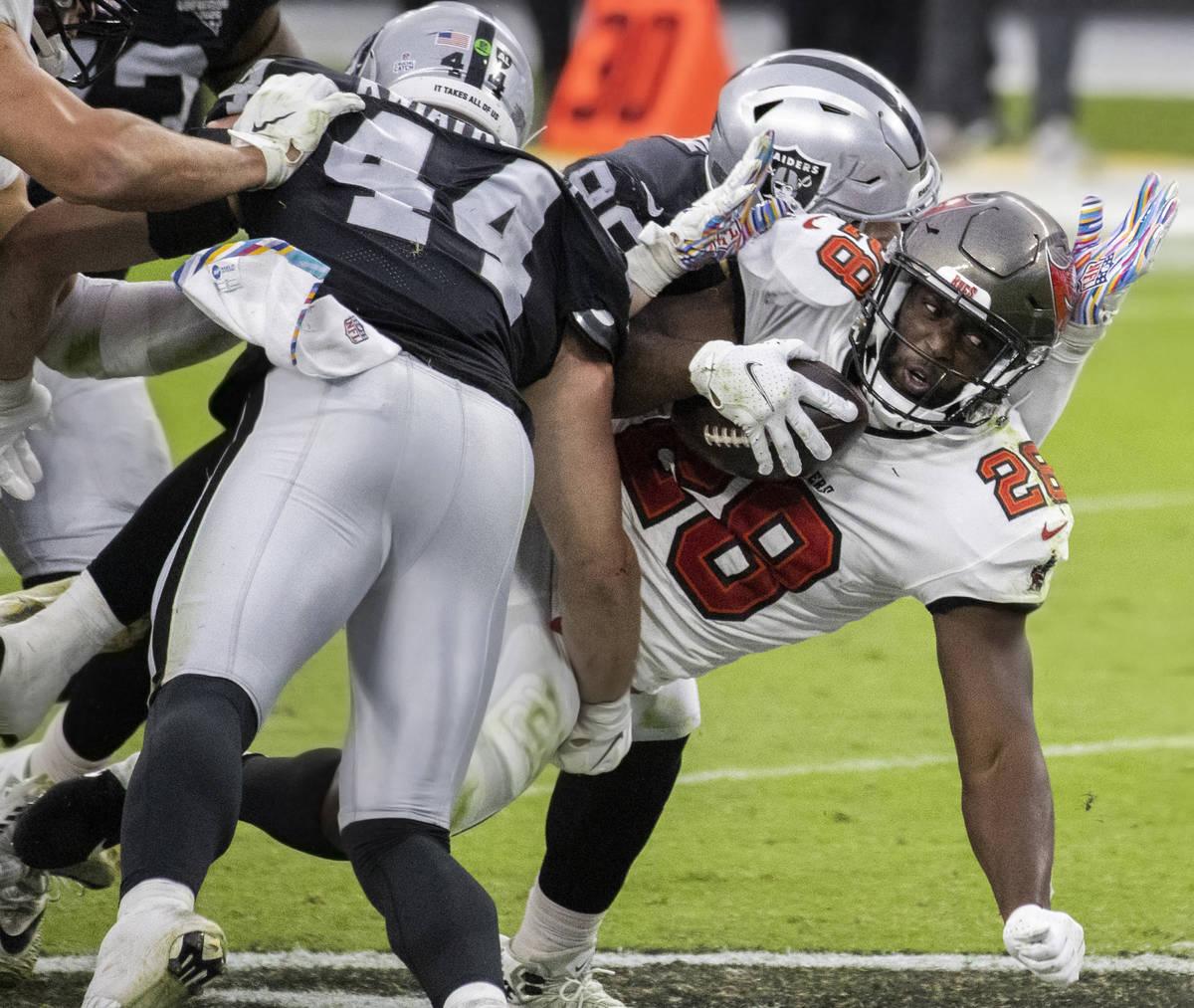 Tampa Bay Buccaneers running back Leonard Fournette (28) fights for extra yardage against Las V ...